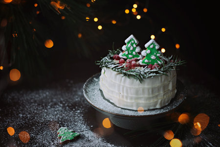 Winter cake with spruce-shaped gingerbread sprinkled with powdered sugar. Christmas treat.の写真素材