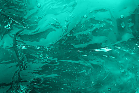 The texture of a mint turquoise color cosmetic gel with bubblesの写真素材