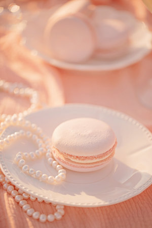 Macarons peach fuzz shade and natural pearls on a saucer. Color concept.の写真素材