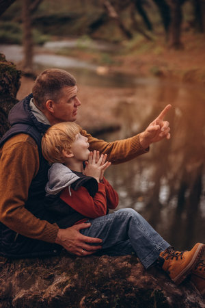 Father and little son tourists autumn time leisure, vacation hiking or traveling touristic activity.の写真素材
