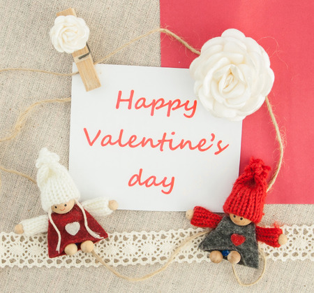 Valentine, greeting card with white roses, pin heart,  knitted loving couple man and woman.の写真素材