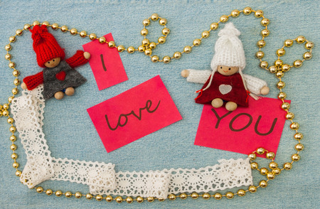 Valentine, greeting card with knitting couple in love and golden beads.の写真素材