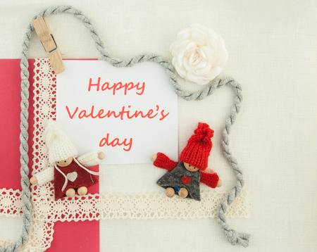 Valentine, greeting card with knitting couple in love and red beads.の写真素材
