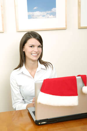 christmas time  - female santa with a laptopの写真素材