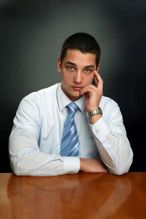 Portrait of a young businessman sitting comfortably.の写真素材