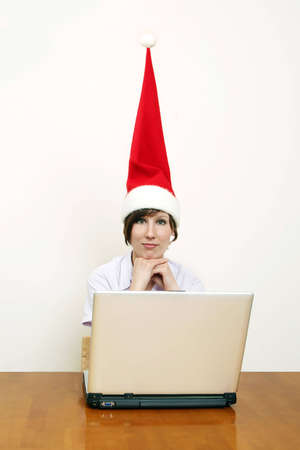 christmas time  - female santa with a laptopの写真素材