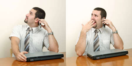 A tired businessman having a boring conversation on mobile phoneの写真素材