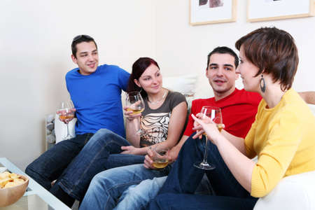 Friends enjoying a celebratory drink of wineの写真素材