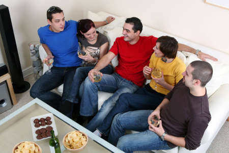 Friends enjoying a celebratory drink of wineの写真素材