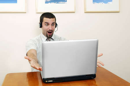 surprised   telephone operator in an office environment.の写真素材