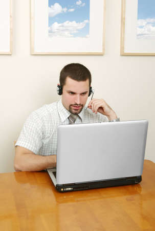 A friendly telephone operator in an office environment.の写真素材