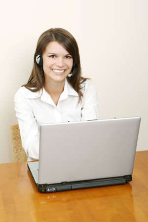 A friendly secretary/telephone operator in an office environmentの写真素材