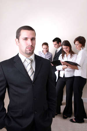 Successful Business Team in a office environment looking satisfied.の写真素材