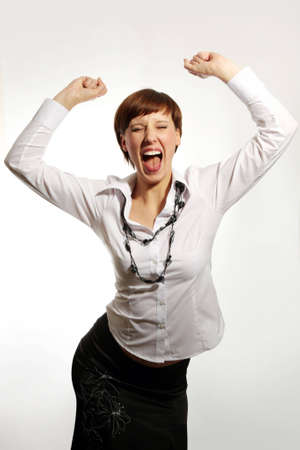 Portrait of an attractive businesswoman with her arms raised in celebration.の写真素材