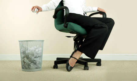 Business woman throwing away paper, low section.の写真素材