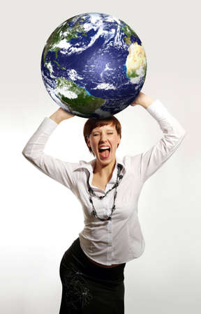 Young attractive businesswoman holding the Earth in her handsの写真素材