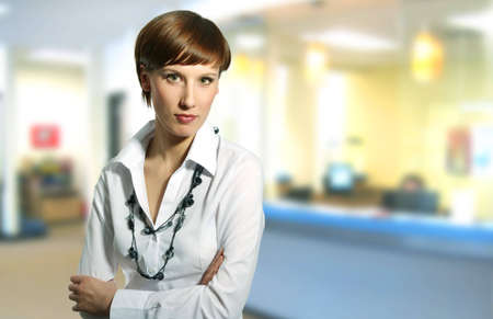 Businesswoman in a office environment, businessteam in bacground.の写真素材