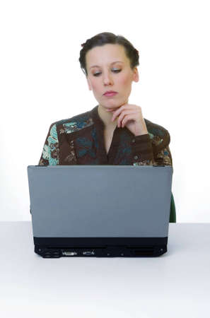 Portrait of an adorable business woman working at her desk with a laptopの写真素材