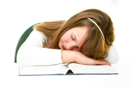 Girl Sleeping with Her Head on an Open Bookの写真素材