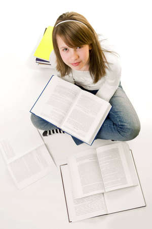 Portrait of Happy young schoolgirl reading booksの写真素材