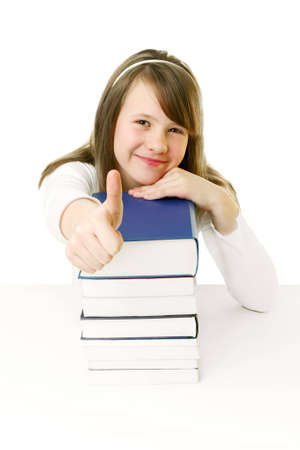 Portrait of Happy young schoolgirl reading bookの写真素材