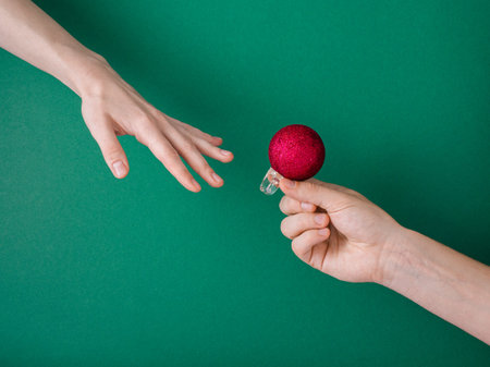 Proposal to present New Year's mood. Creative concept of giving Christmas mood. A man gives...