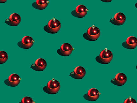 Christmas composition. Christmas red balls on green background. Flat lay, top view, copy space. Minimal styleの写真素材