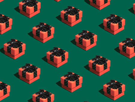 Minimal composition background of red Christmas gift box on green background. New Year concept. Christmas isometric pattern, background, banner.の写真素材