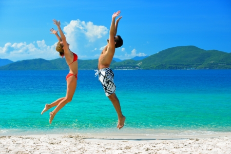 A young couple on a beach vacation on the background of the islandsの写真素材
