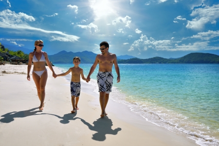 The European family relaxing on the white sandy beach in Asia の写真素材