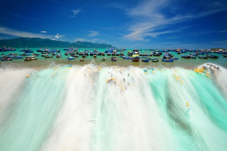 Fishing nets on the background of the bay with boats and ships の写真素材