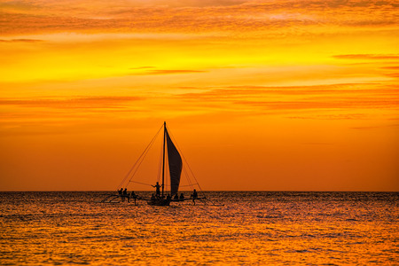 Sailing boat in the beautiful golden sunsetの写真素材