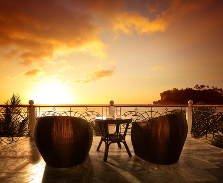 Terrace lounge with rattan armchairs and seaview in a luxury resort . Summer holiday conceptの写真素材