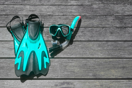 Scuba diving and snorkelling. Flippers, mask, snorkel on wood brown backgroundの写真素材