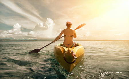 Woman in bikini exploring calm tropical beach by canoe.
Travel and active lifestyle, happiness emotion, summer holiday concept.の写真素材