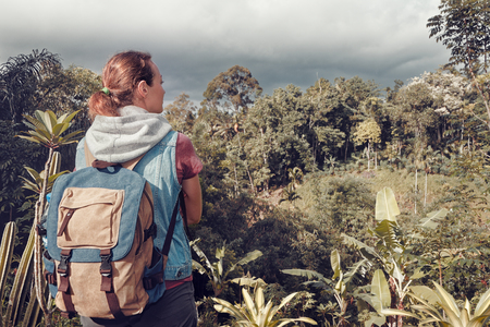 Hiker woman with backpack relax and enjoying view to rain forest .
Traveling along mountains and jungle, freedom and active lifestyle conceptの写真素材