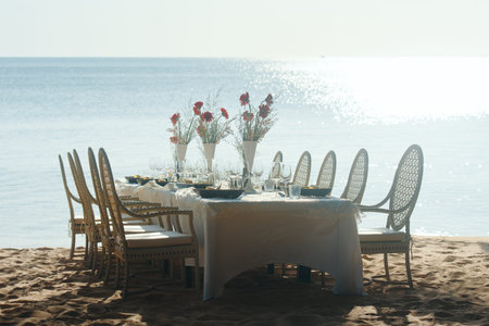 Festive serving table on beach in sunny day.