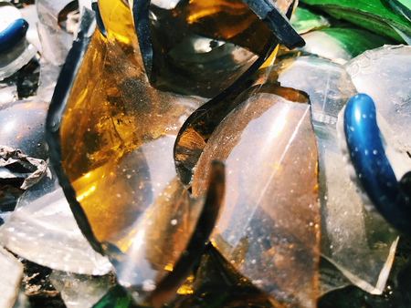 A lot of broken color bottle. Glass backgroundの写真素材
