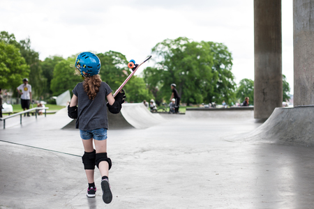 Powerful funny young guys are trained in a skate parkの写真素材