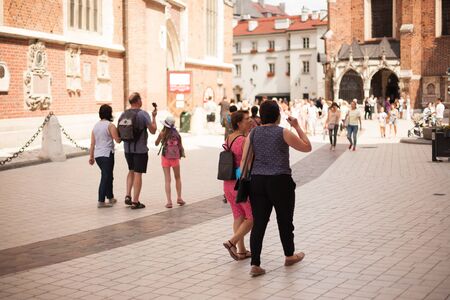 Krakow, Poland. Tourist taking photos in center of cityのeditorial素材