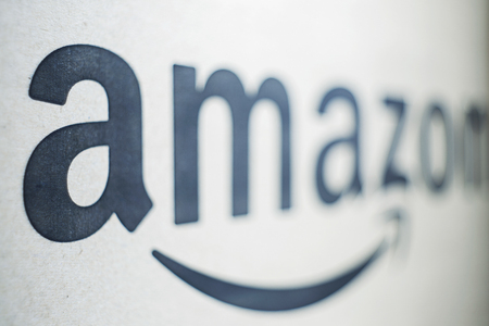 KIEV, UKRAINE - January 02, 2018: Black and white Amazon logotype printed on paper. An American electronic commerce companyのeditorial素材