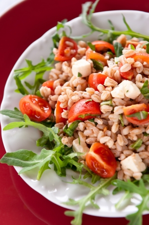 Summer salad with spelt, rucola, cherry tomato and greek cheese fetaの写真素材