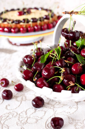 Fresh cherries in the ceramic white basketの写真素材