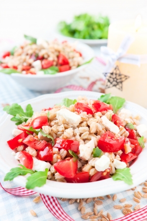 Italian salad with spelt, rucola, cherry tomato and greek cheese fetaの写真素材