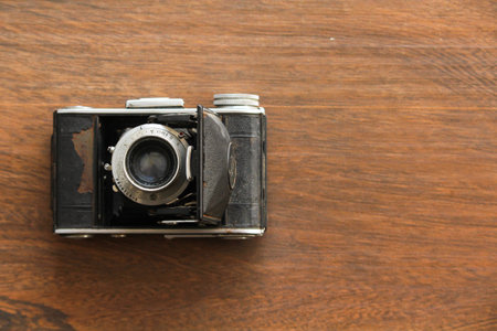 Vintage camera on the wooden background