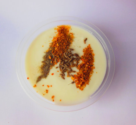 cup of Curd with seasoning black salt cumin and red chili Top Viewの写真素材