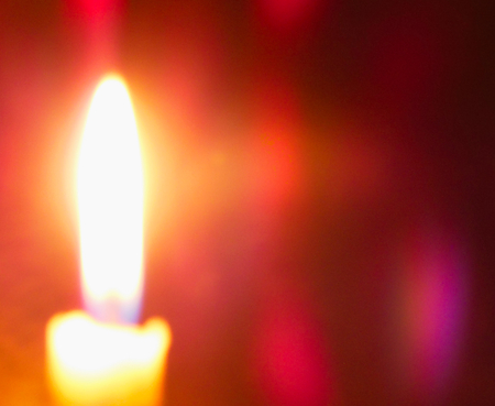 Candle flame closeup out of focus blue effect space for message or iconの写真素材