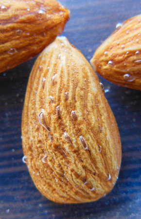 close up of Almond nuts dipped soak in water with water bubblesの写真素材