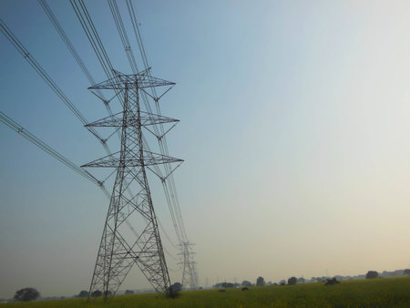 High power electric transmission line pillar row with beautiful blue sky backgroundの写真素材