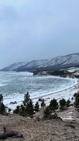 Sunset beach Lake Baikal with rocks front and snow the shore Baikal in winterの写真素材